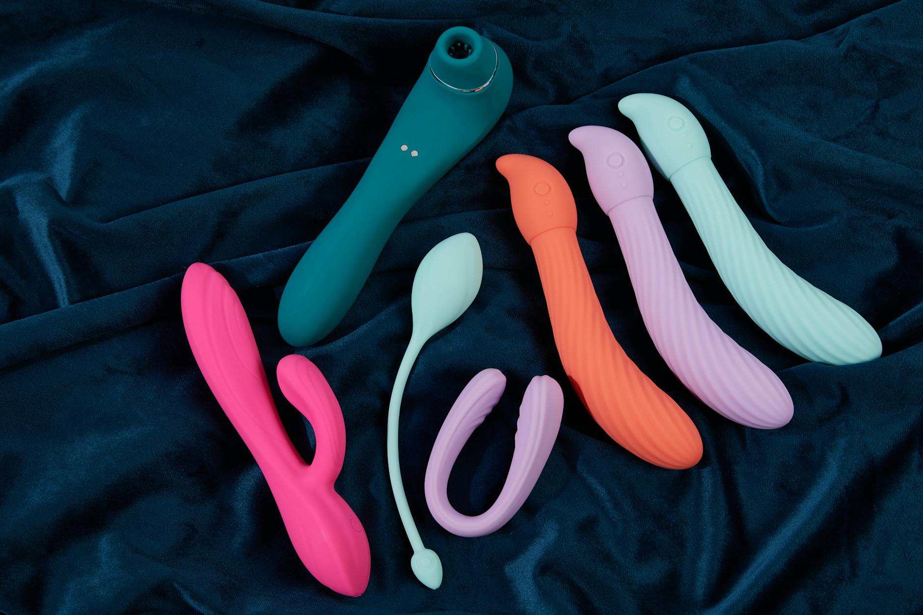 Yellow silicone lemon vibrator surrounded by bananas on a bright yellow background