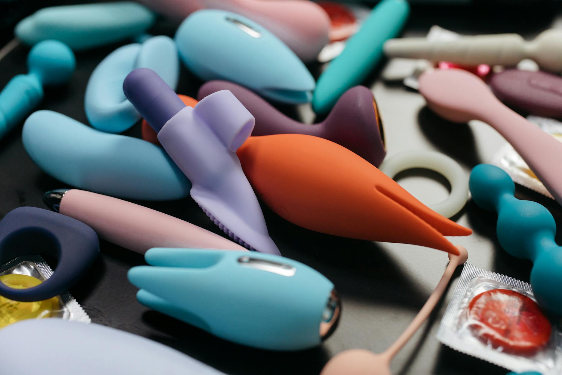 A collection of colorful silicone vibrators and sex toys arranged together