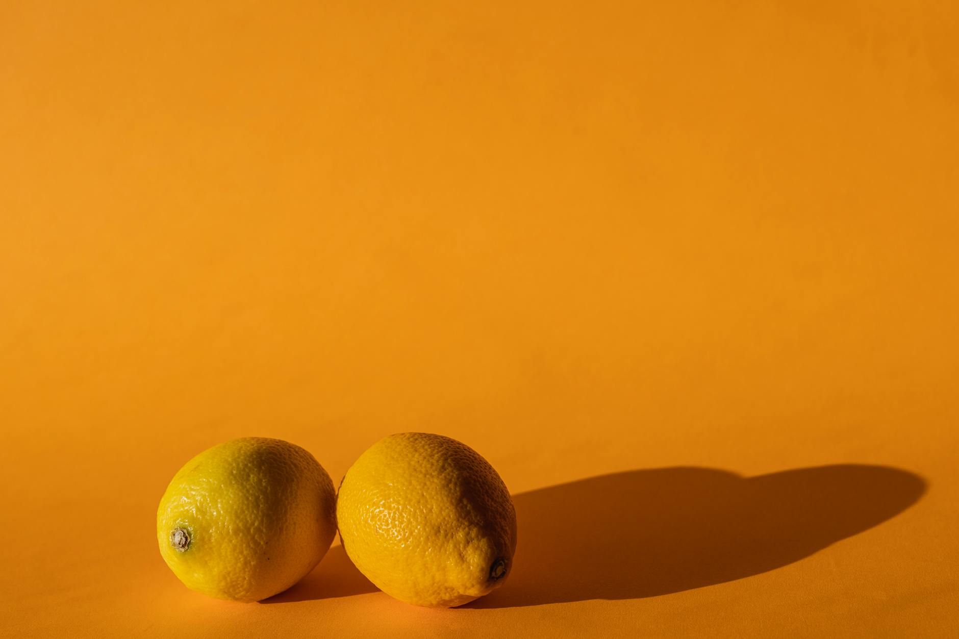 Bright yellow lemons on a warm yellow background, symbolizing individual desire and personal pleasure